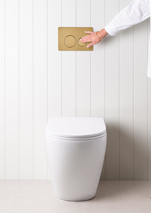 Curved In-Wall Toilet With Round Brushed Brass Buttons