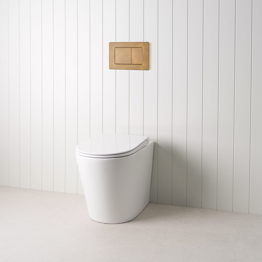 Angled In-Wall Toilet With Rectangle Antique Brass Buttons