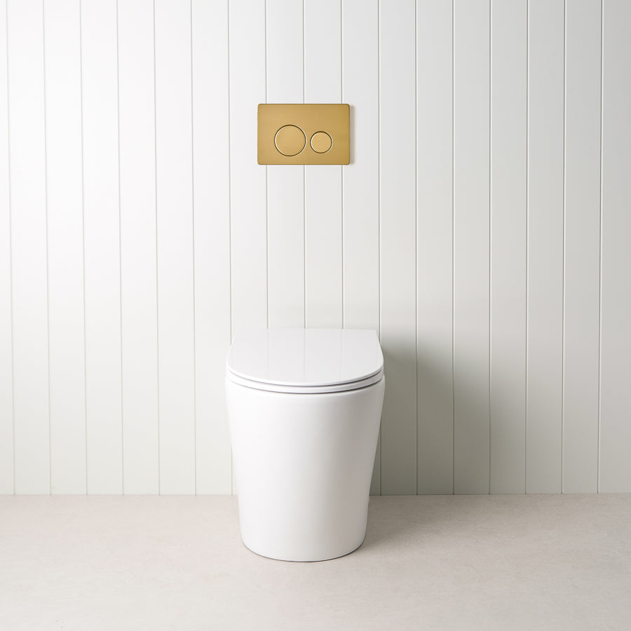 Angled In-Wall Toilet With Round Brushed Brass Buttons